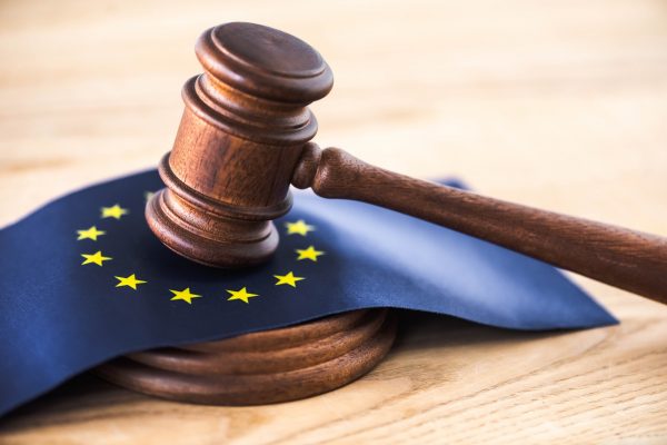 gavel of judge with european union flag on wooden table